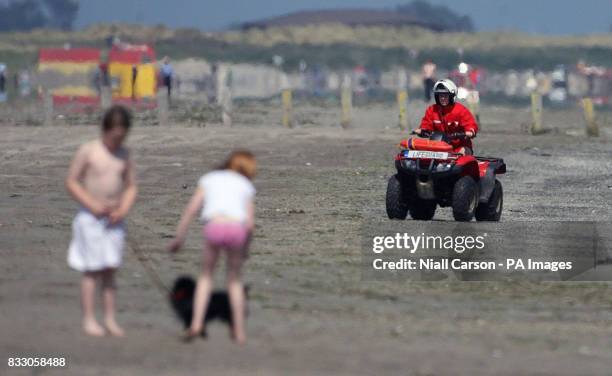 Lifeguard on a quad bike rides along Dollymount Strand, Dublin, which has failed to secure the coveted Blue Flag status for environmental excellence.