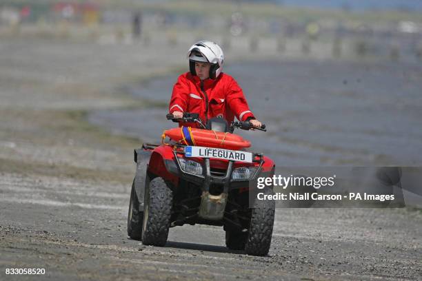 Lifeguard on a quad bike rides along Dollymount Strand, Dublin, which has failed to secure the coveted Blue Flag status for environmental excellence.