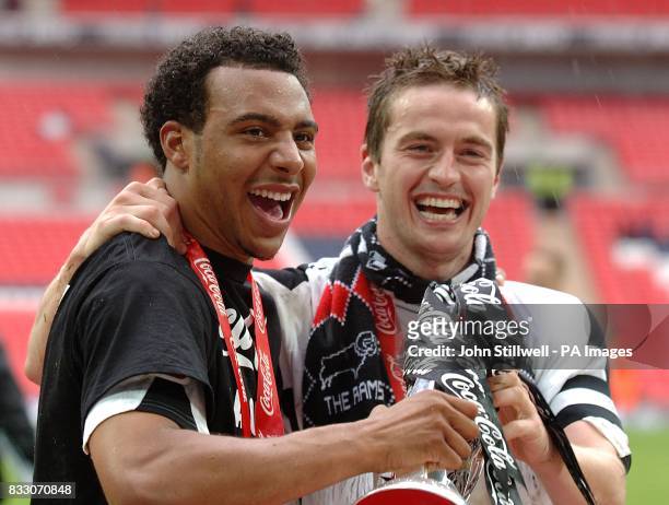 Derby County's Giles Barnes and Matt Oakley celebrate winning promotion.