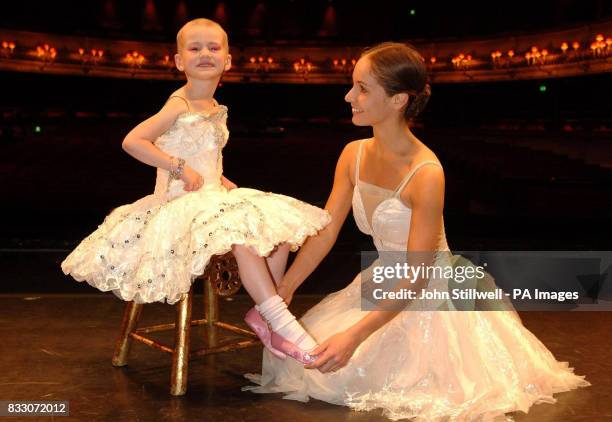 Four-year-old Angelina Vidler, of Shoeburyness, Essex, has her shoes adjusted by prima ballerina Francesca Filpi as she fulfils her dream of being a...