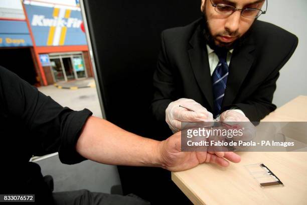 Motorist Mark Hancock from Tamworth, Cholesterol test as part of a heart health check from Shafeeque Mohammed from Lloyds Pharmacy, during the launch...
