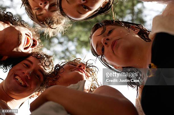 group of people looking down at camera - group arm in arm stock pictures, royalty-free photos & images