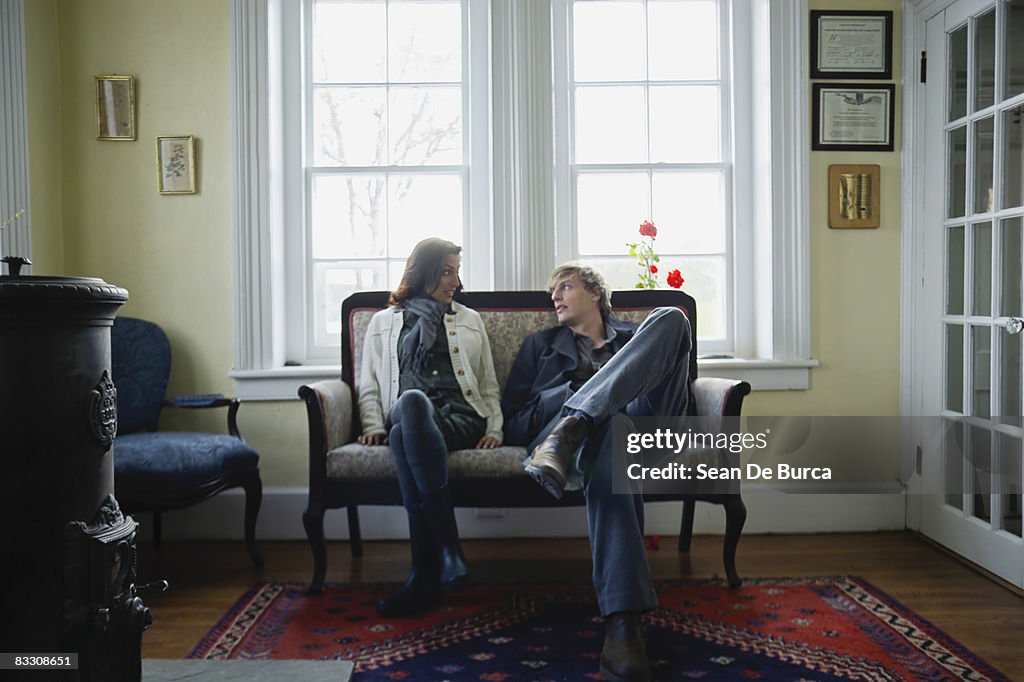 Relaxed couple conversing indoors