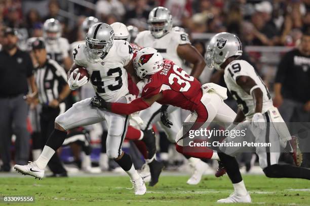 Running back John Crockett of the Oakland Raiders rushes the footballl against the Arizona Cardinals during the NFL game at the University of Phoenix...