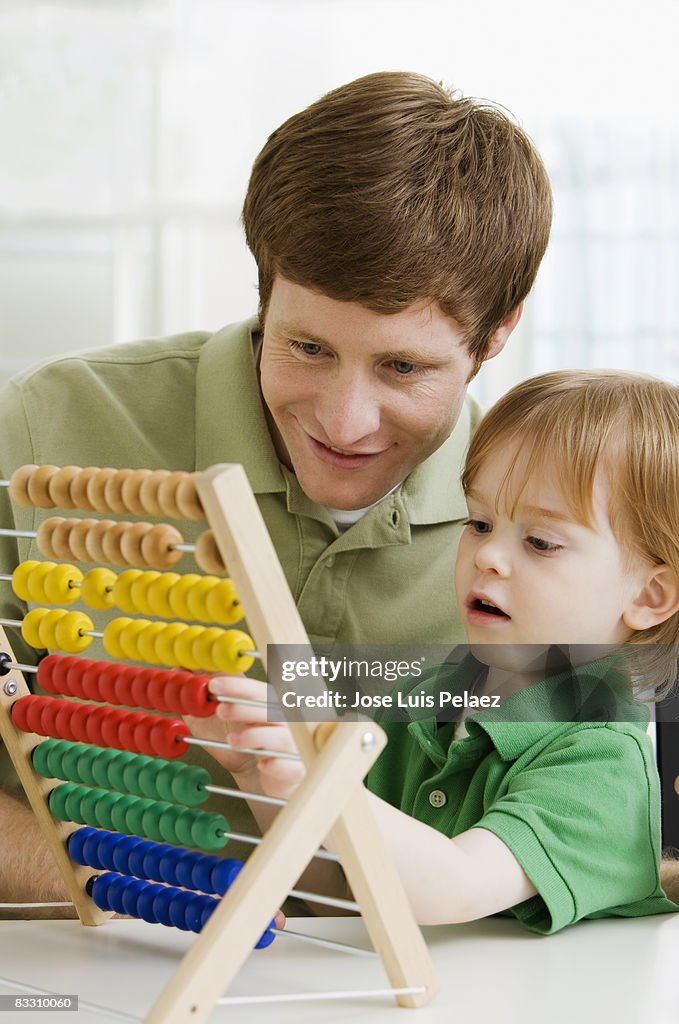 Father and son playing with abacus 