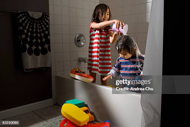 sister and brother playing in the bathtub. - brothers bathroom bildbanksfoton och bilder