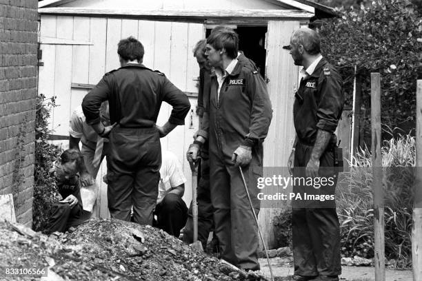 Police in Hungerford searching the garden of the burnt out house of Mrs Dorothy Ryan, the 60 year old mother of Michael Ryan who went beserk shooting...