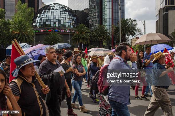 Demonstrators march past the Mexican Stock Exchange during a protest against the North American Free Trade Agreement in Mexico City, Mexico, on...