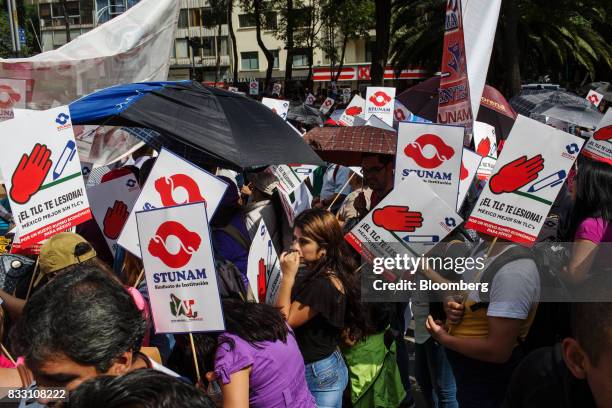 Demonstrators hold signs during a protest against the North American Free Trade Agreement in Mexico City, Mexico, on Wednesday, Aug. 16, 2017. U.S....