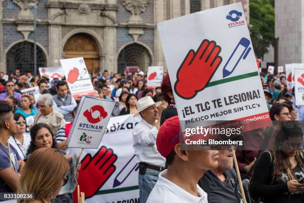 Demonstrators hold signs during a protest against the North American Free Trade Agreement in Mexico City, Mexico, on Wednesday, Aug. 16, 2017. U.S....