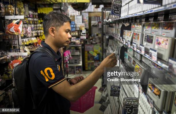 Thai tourist shops for video games for the Nintendo Co. Super Nintendo Entertainment System console at the Super Potato video game store in the...