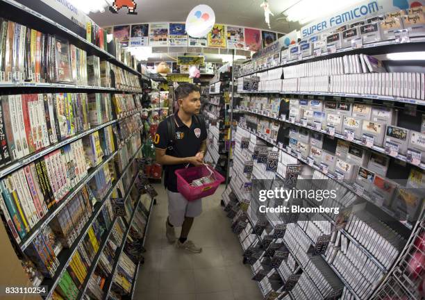 Thai tourist shops for video games for the Nintendo Co. Super Nintendo Entertainment System console at the Super Potato video game store in the...