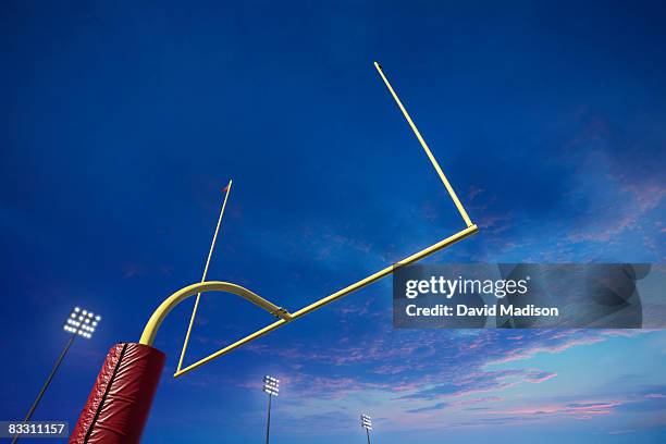 american football goalpost at sunset - palo della porta foto e immagini stock