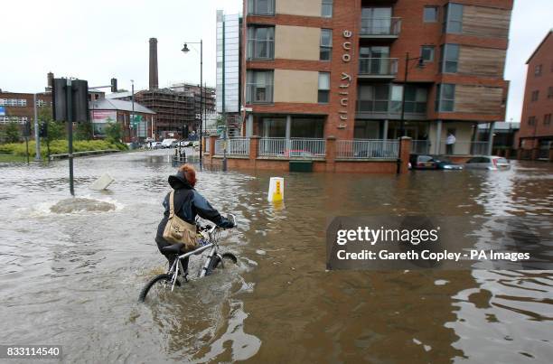 City centre residents make their way home after the banks of the River Aire in Leeds city centre were broken by heavy rainfall.