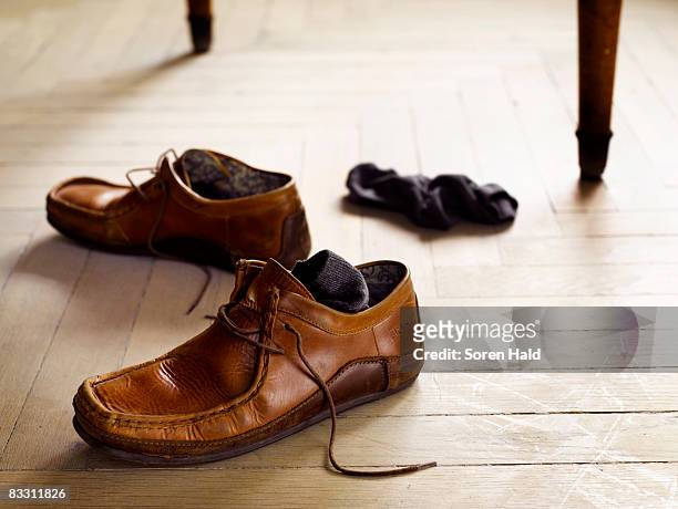 a pair of shoes and socks on the floor - brown shoe stock pictures, royalty-free photos & images