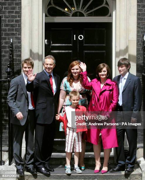 Prime Minister Tony Blair accompanied by his family pose on the steps of No.10 as they leave Downing Street, London for the final time.