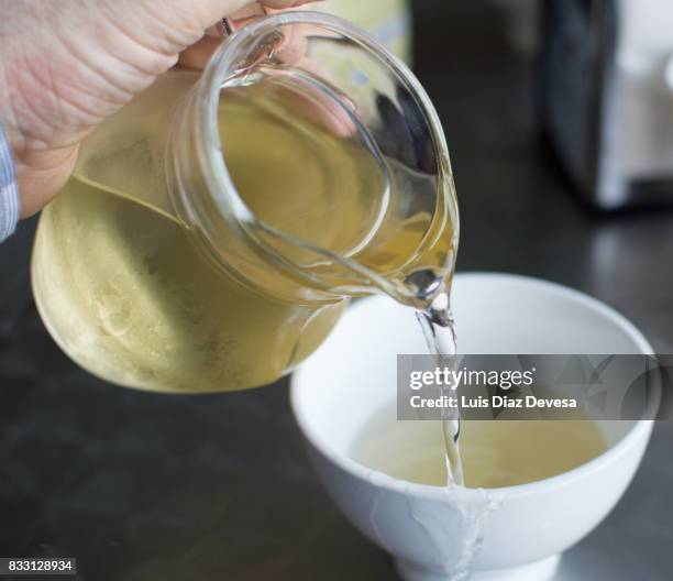 serving wine in a white earthenware cup with a glass jug - tongeschirr stock-fotos und bilder