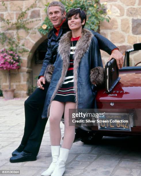 American actor Steve McQueen with his wife, Filipino-american actress Neile Adams, sitting on a Ferrari 275 Cabriolet, Beverly Hills, 1970.