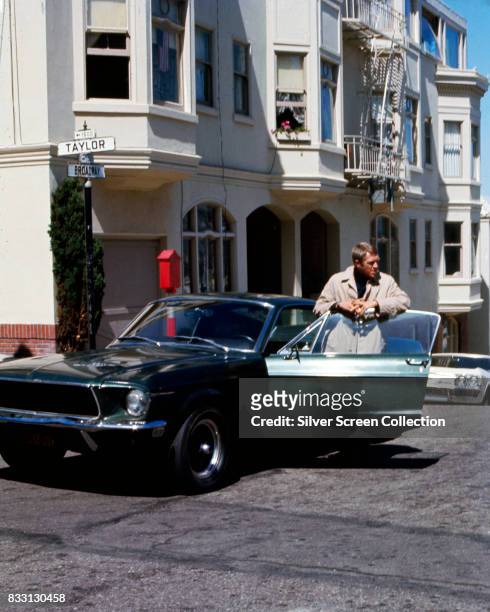 American actor Steve McQueen as Frank Bullit next to a Ford Mustang 390 GT 2+2 Fastback in the american crime thriller movie 'Bullitt', San...