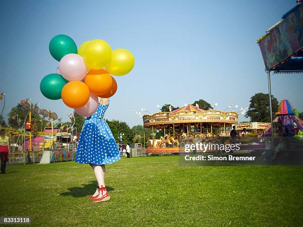 woman with balloons at fair - 遊園地 ストックフォトと画像