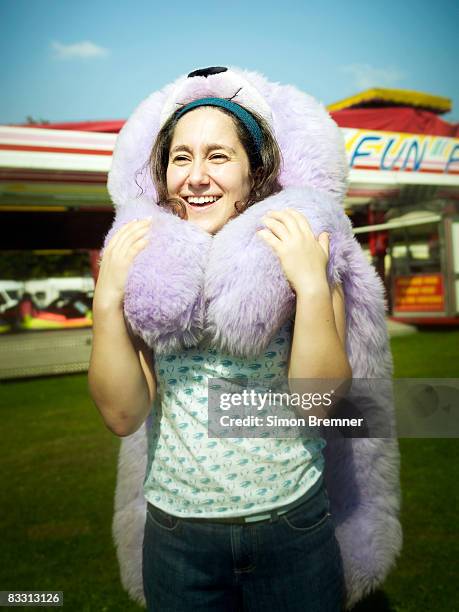 woman with huge teddy bear at funfair - london toy fair stock pictures, royalty-free photos & images