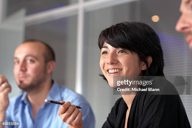 office meeting - confident businessman sitting with colleagues in office stock pictures, royalty-free photos & images