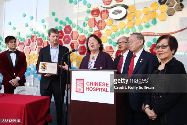 Actor Philip Ng and director George Nolfi present Chinese Hospital CEO Brenda Yee and board members with a commemorative plaque at a special press...