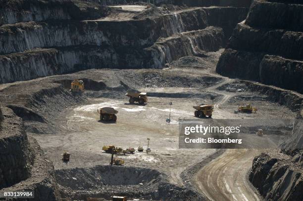 Bulldozers and excavators operate in the Invincible open pit mine at the St Ives Gold Mine operated by Gold Fields Ltd. In Kambalda, Australia, on...