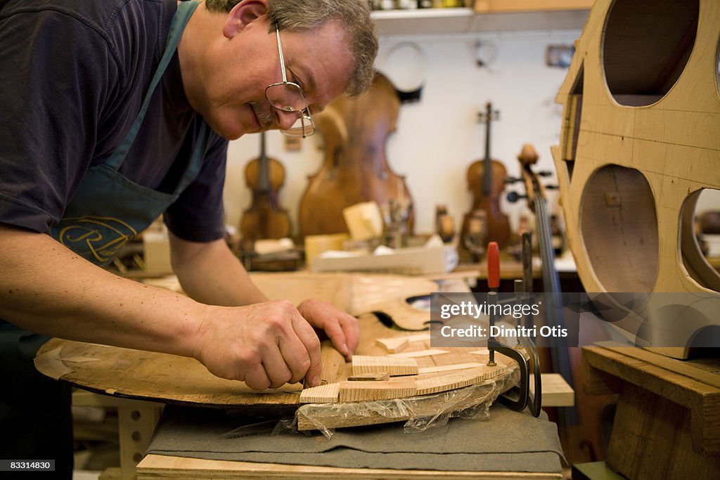 Craftsman making chello in his workshop
