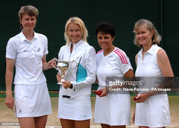 Czech Republic's Jana Novotna with partner Helena Sukova with the trophy after winning against USA's Rosalyn Nidefferand South Africa's Ilana Kloss...