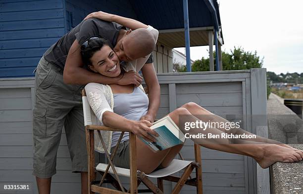 man surprises his partner with a kiss - book richardson stock pictures, royalty-free photos & images