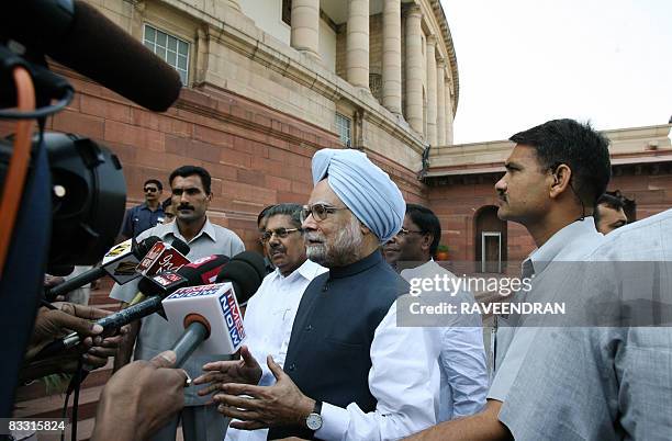 Indian Prime Minister Manmohan Singh speaks to the media outside Parliament house in New Delhi on October 17, 2008 on his arrival to attend the...