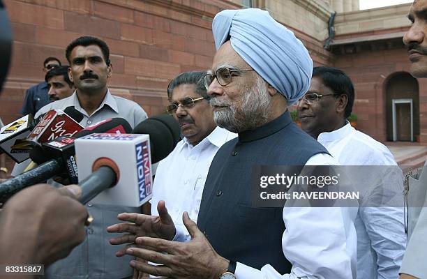 Indian Prime Minister Manmohan Singh speaks to the media outside Parliament house in New Delhi on October 17, 2008 on his arrival to attend the...