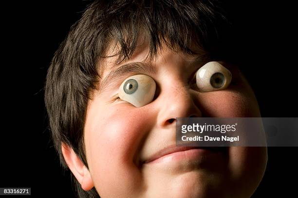 boy with fake eyeballs in front of his eyes - occhio di vetro foto e immagini stock
