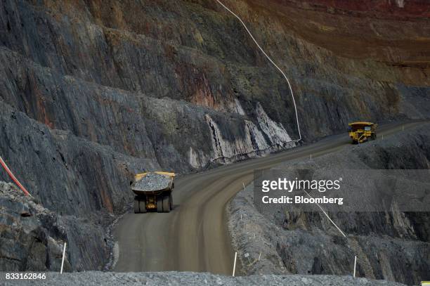 Dump trucks travel along an access ramp of the Invincible mine at the St Ives Gold Mine operated by Gold Fields Ltd. In Kambalda, Australia, on...