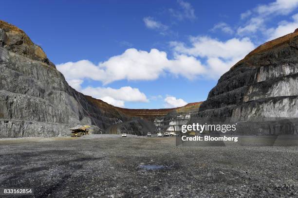 Dump trucks and excavators operate in the Invincible open pit mine at the St Ives Gold Mine operated by Gold Fields Ltd. In Kambalda, Australia, on...