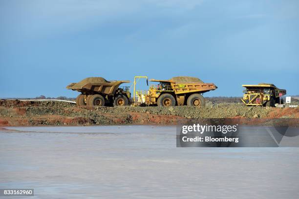 Dump trucks sit beyond a salt lake at the St Ives Gold Mine operated by Gold Fields Ltd. In Kambalda, Australia, on Wednesday, Aug. 9, 2017. Global...