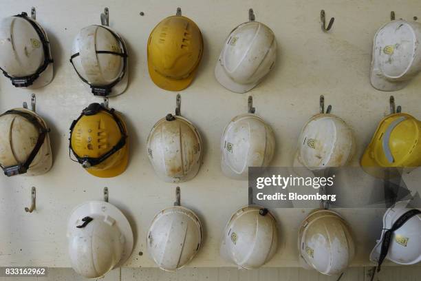 Safety helmets hang from pegs on a wall at the St Ives Gold Mine operated by Gold Fields Ltd. In Kambalda, Australia, on Wednesday, Aug. 9, 2017....