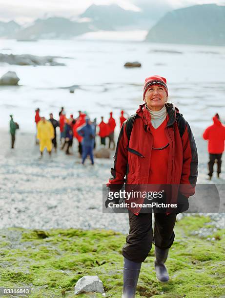 woman walking up hill with camera - mageroya island stock pictures, royalty-free photos & images