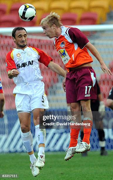 Mitchel Nichols of Roar and Michael Valkanis of United compete for the ball during the round four National Youth League match between the Queensland...