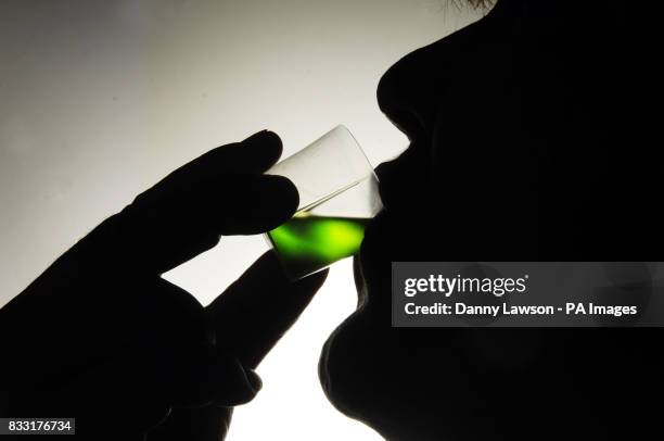 Member of the public takes his prescription of methadone at a Houlihan pharmacy in Glasgow.