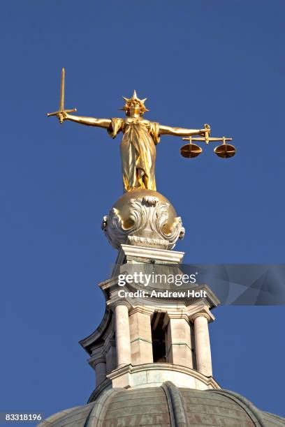 gold statue of justice blue background - statua della giustizia foto e immagini stock
