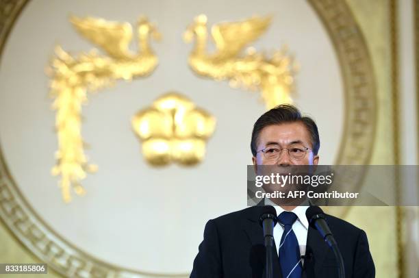 South Korea's President Moon Jae-In speaks during a press conference marking his first 100 days in office at the presidential house in Seoul on...