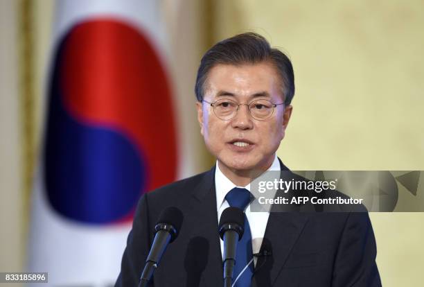 South Korea's President Moon Jae-In speaks during a press conference marking his first 100 days in office at the presidential house in Seoul on...