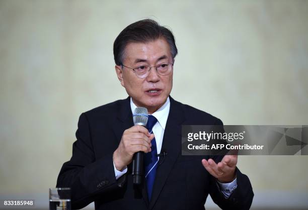 South Korea's President Moon Jae-In speaks during a press conference marking his first 100 days in office at the presidential house in Seoul on...