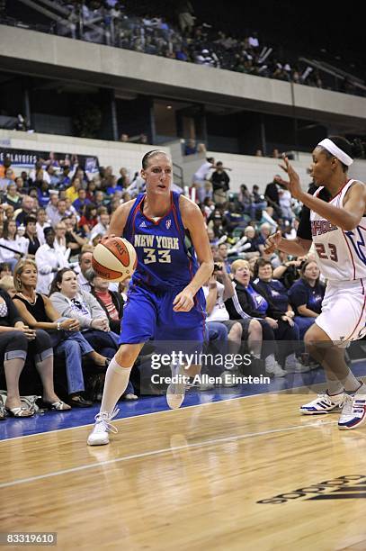 Cathrine Kraayeveld of the New York Liberty drives to the basket against Plenette Pierson of the Detroit Shock in Game Two of the Eastern Conference...