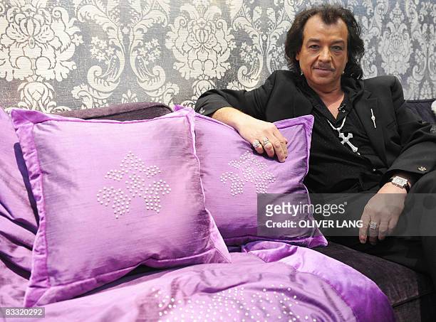 Designer Alfredo Pauli poses with cushions and a blanket embedded with diamonds with a price-tag of 300,000 Euro at the "Millionaire Fair Munich...