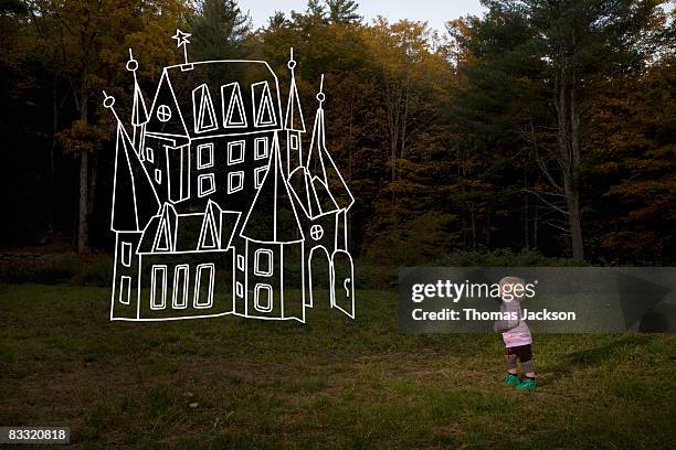 Child in field looking at imaginary house