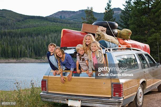 kids hanging out of back of station wagon - station wagon stock pictures, royalty-free photos & images
