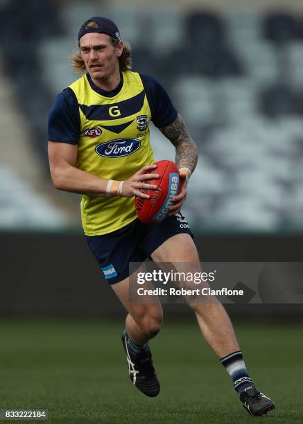 Tom Stewart of the Cats runs with the ball during a Geelong Cats AFL training session at Simonds Stadium on August 17, 2017 in Geelong, Australia.